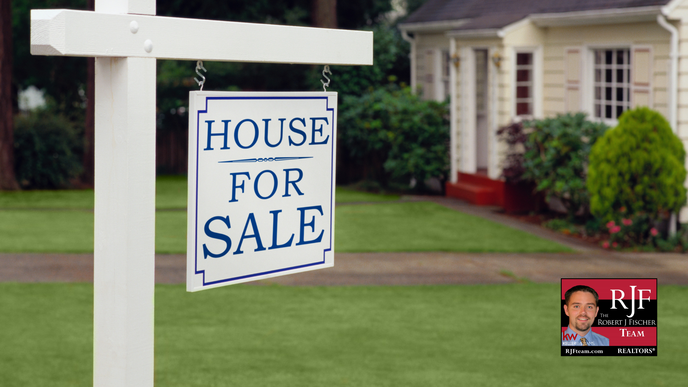 A for sale sign in front of a house with the Robert J Fischer Team logo in the bottom right corner
