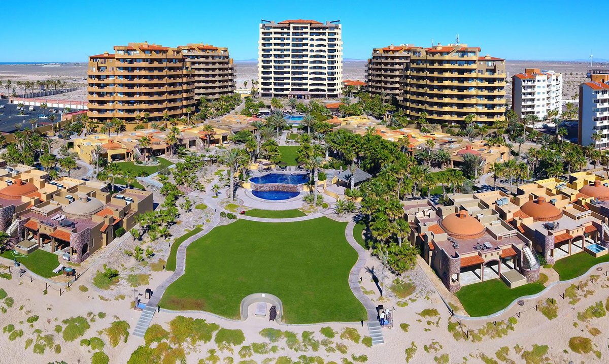 Aerial overview of Bella Sirena resort and its beachfront buildings and villas on Sandy Beach, Rocky Point