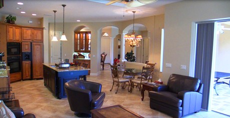 Long view of the Kitchen, Family, Dining and Living Rooms at 3566 Founders Club Dr, Sarasota, FL
