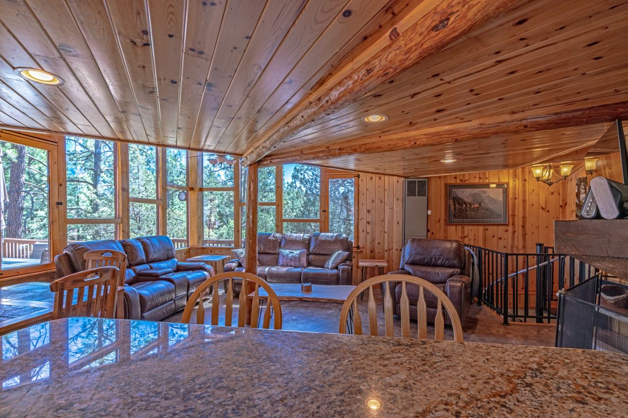 Wood cabinetry granite kitchen countertops and black refrigerator at Greystone Circle