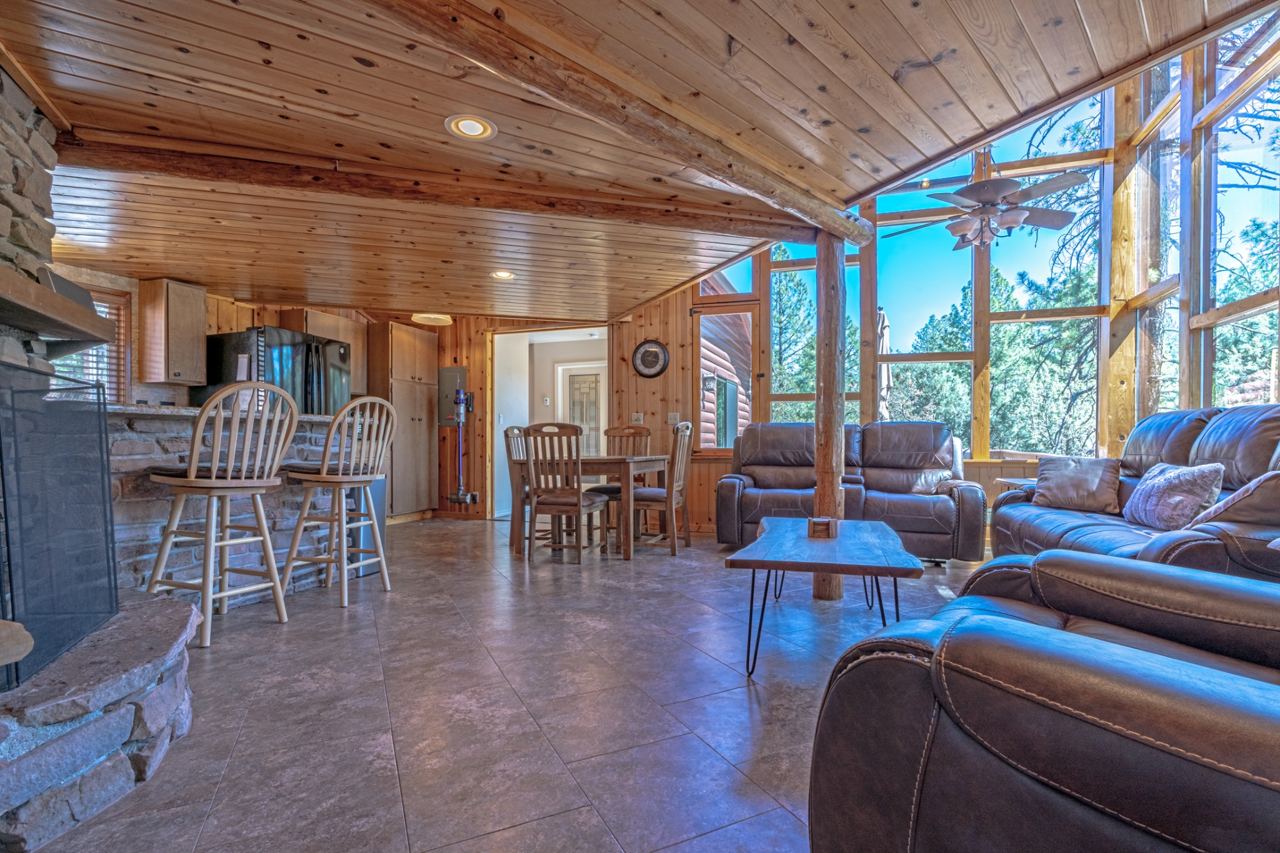 Living room at 190 S Greystone Circle with tall windows overlooking the pines