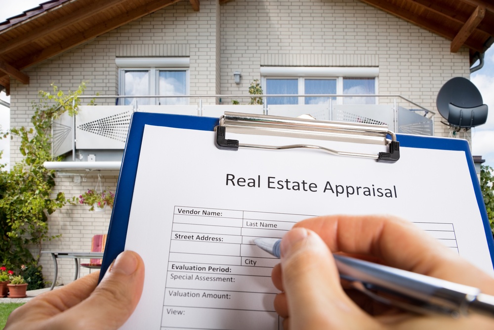 Homebuyer reviewing mortgage and appraisal waiver documents before purchasing a Maryland home