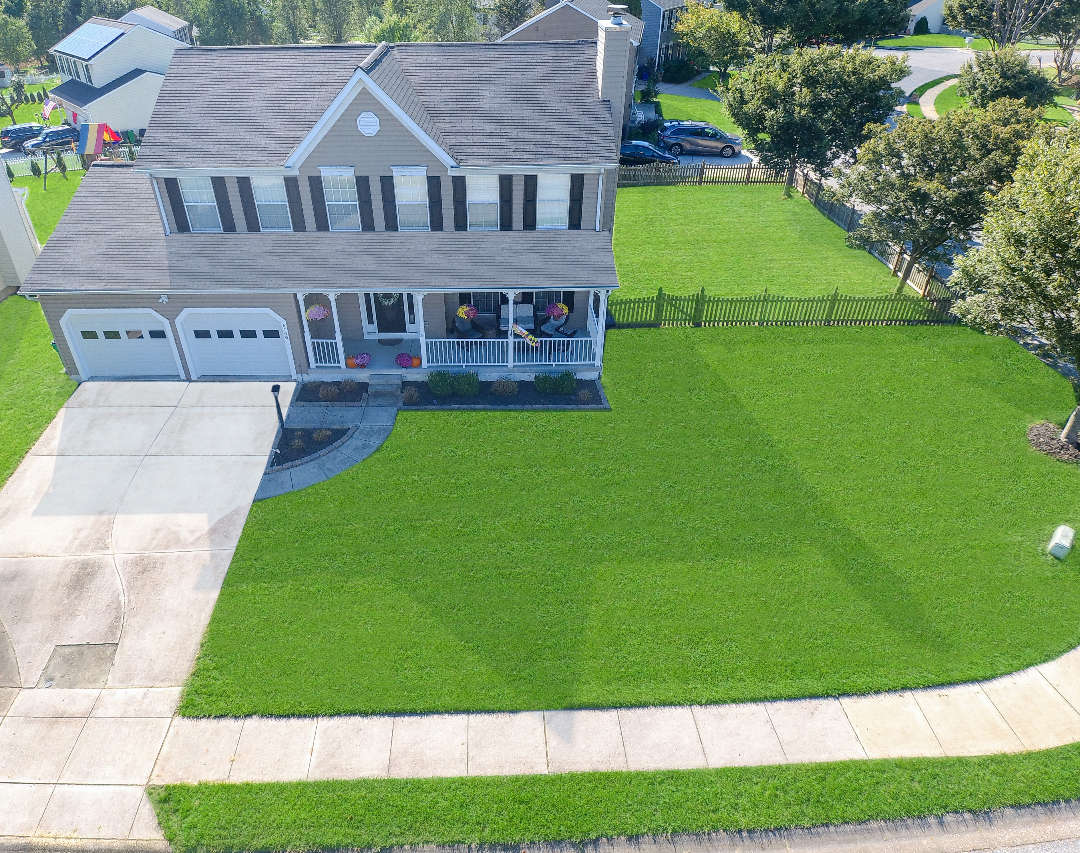 Aerial drone photo showing a residential property and surrounding neighborhood