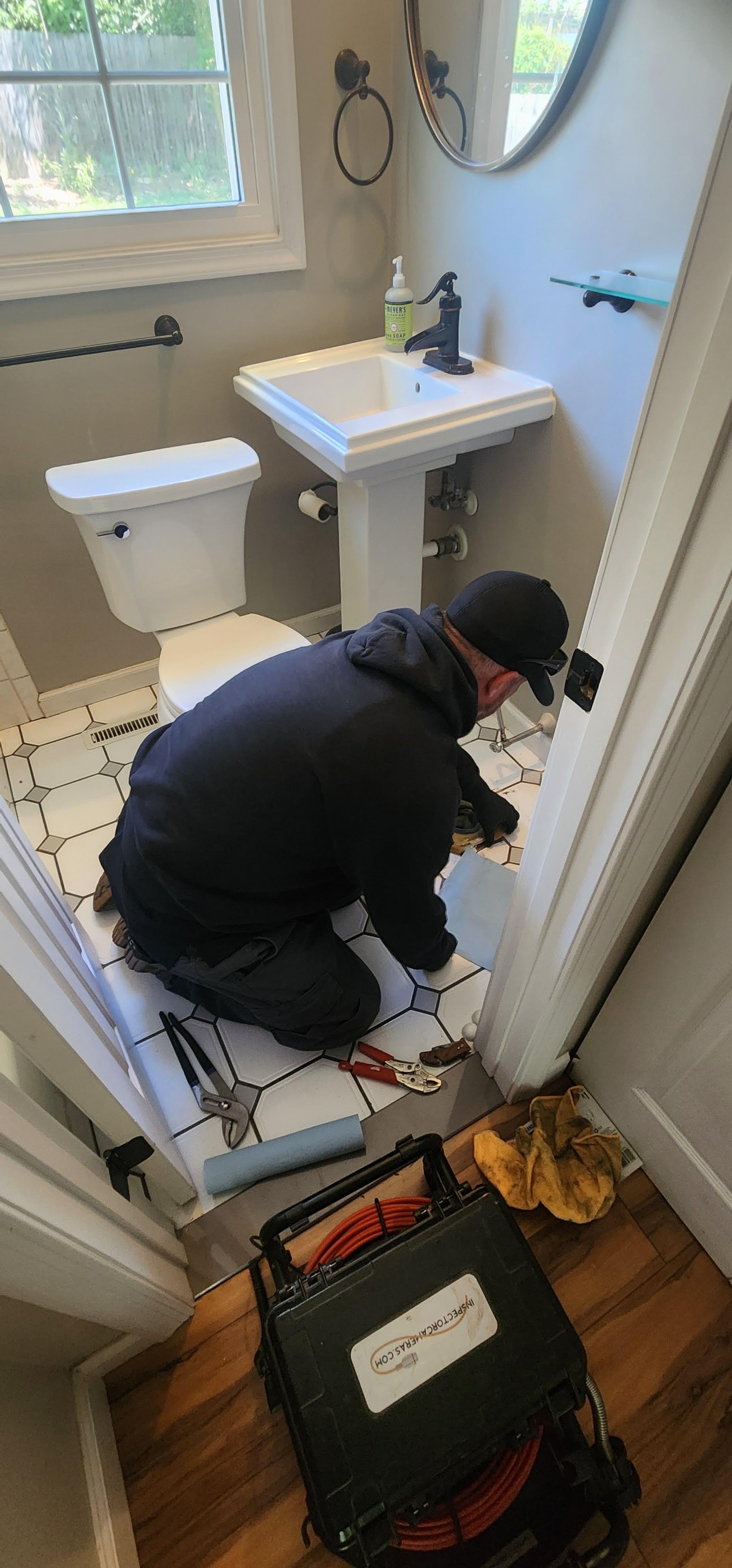 Home inspector performing a sewer line camera inspection during a Maryland home inspection