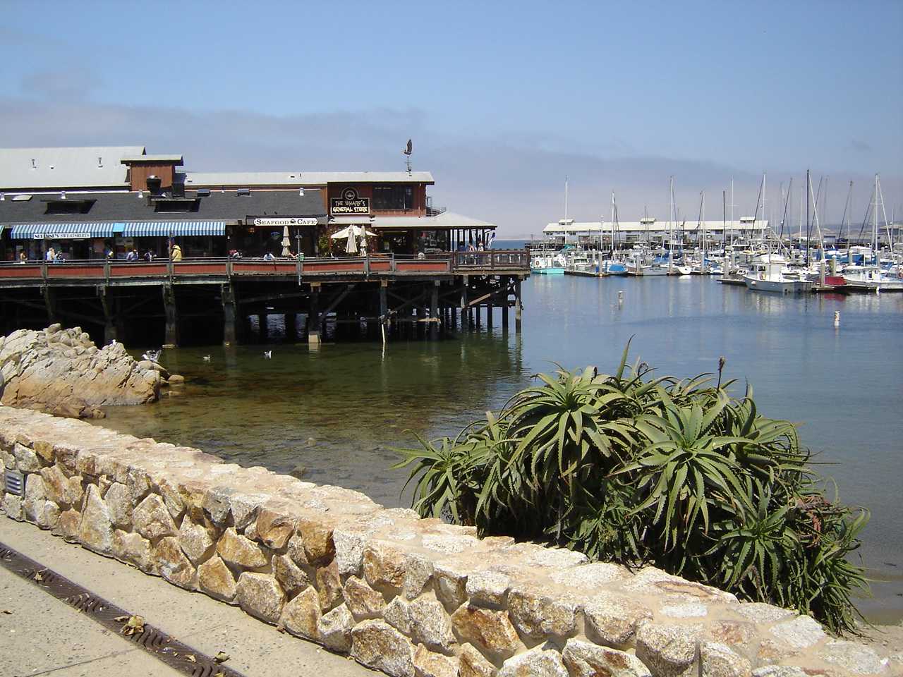 Fisherman&rsquo;s Wharf in Monterey, California, with waterfront buildings and sailboats