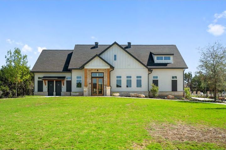 New two-story home behind a green lawn