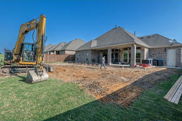 Home site under construction with an excavator