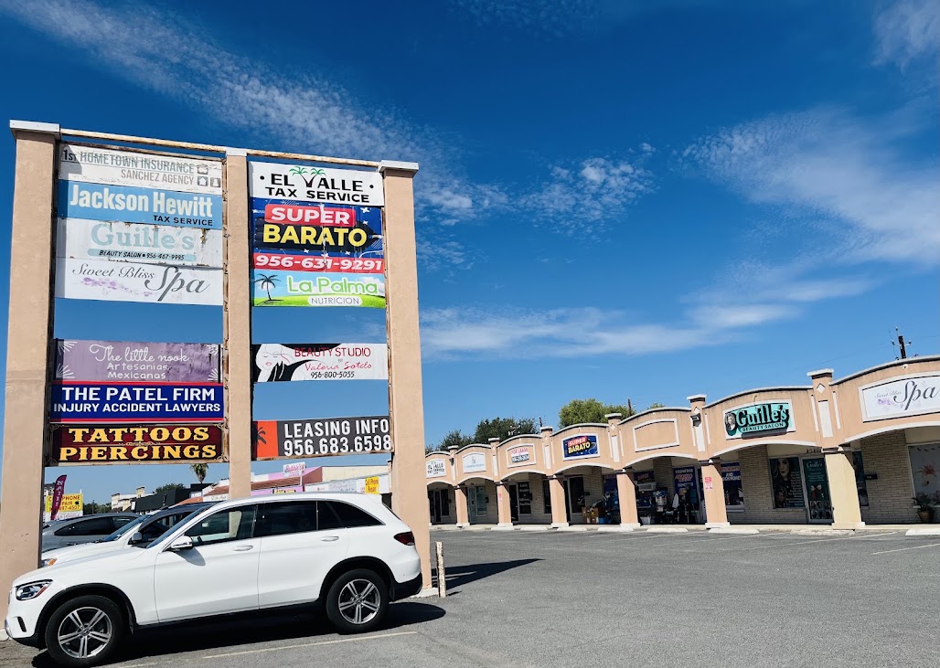 Retail plaza with tenant signs and leasing information on W Pecan Boulevard in McAllen, Texas
