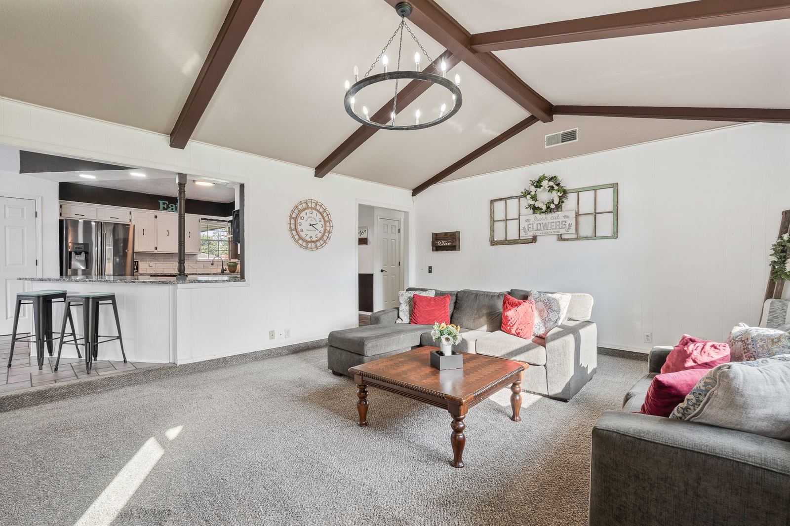 Living room with vaulted ceiling open to the kitchen bar-top seating at 3309 Burrus Place Amarillo TX