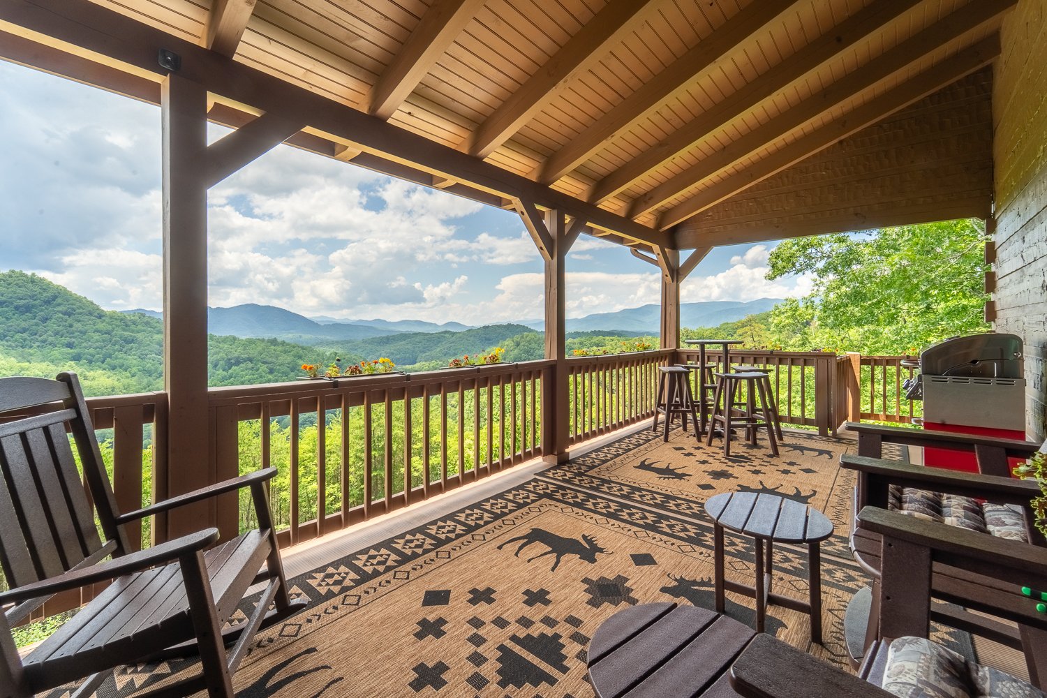 Covered porch with bar seating overlooking the valley