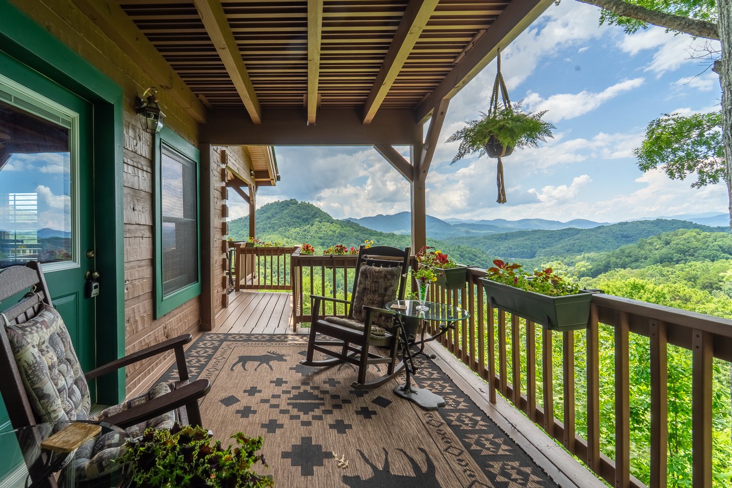Covered porch with rocking chairs and a long-range mountain view