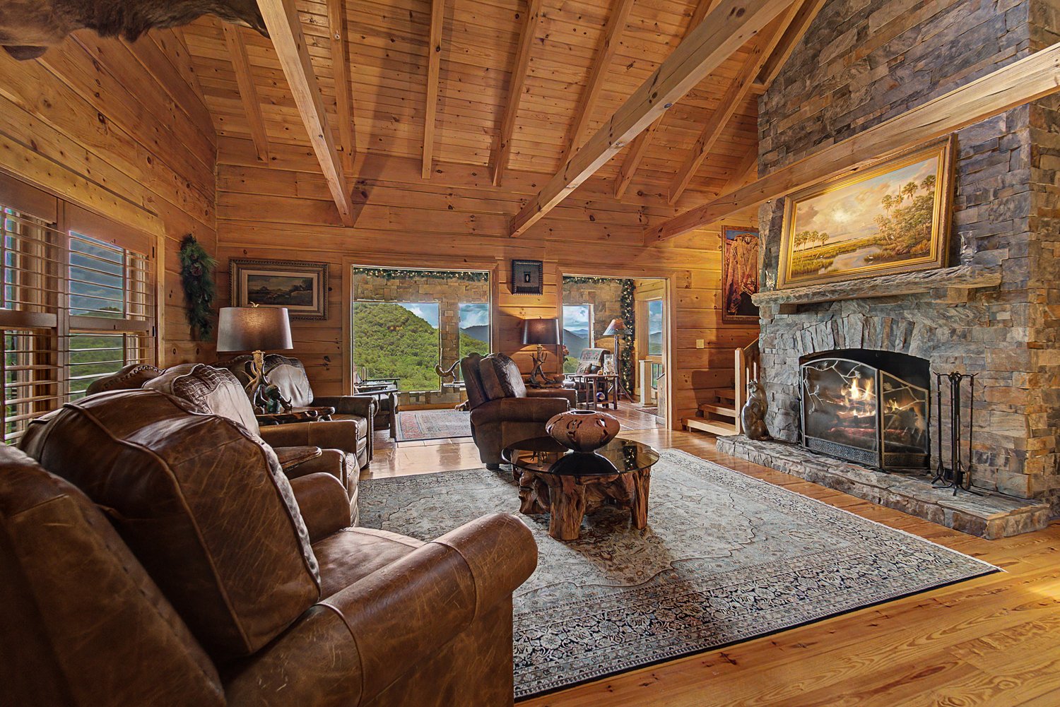 Living area with leather seating beside the stone fireplace