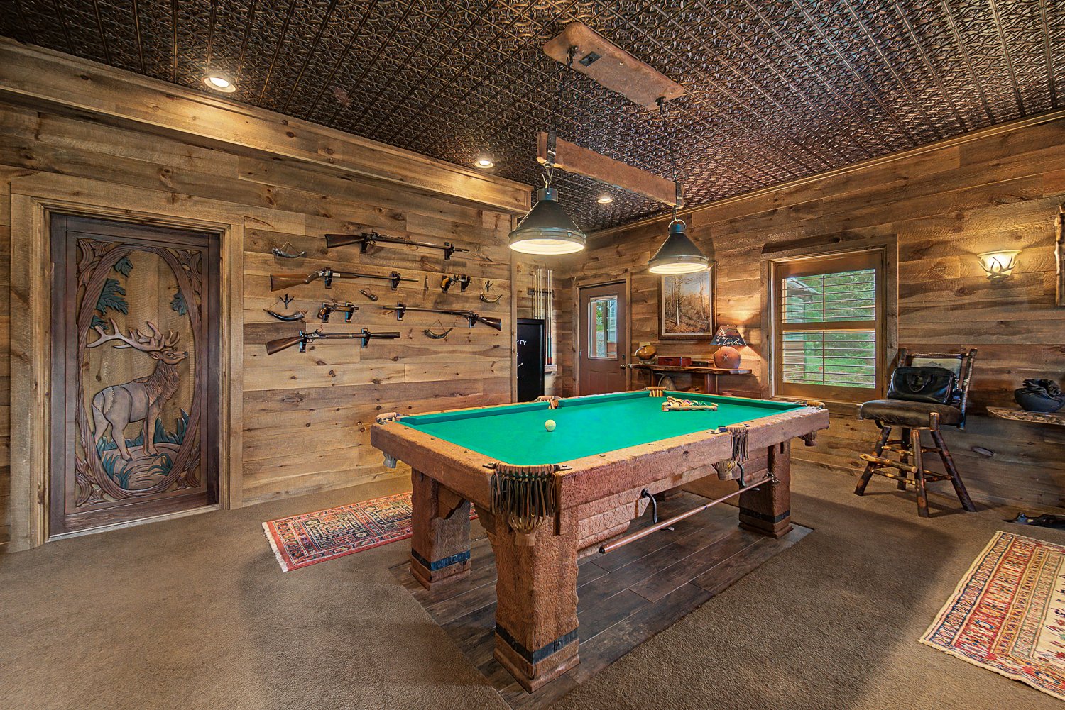 Lower level game room with a pool table and wood-paneled walls