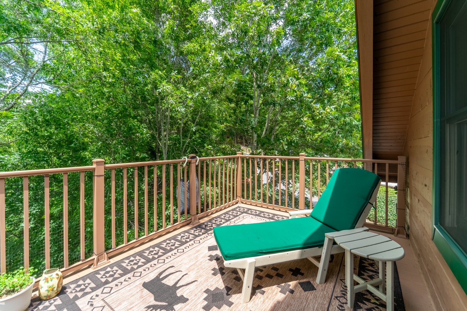 Open deck with lounge chairs above the treetops