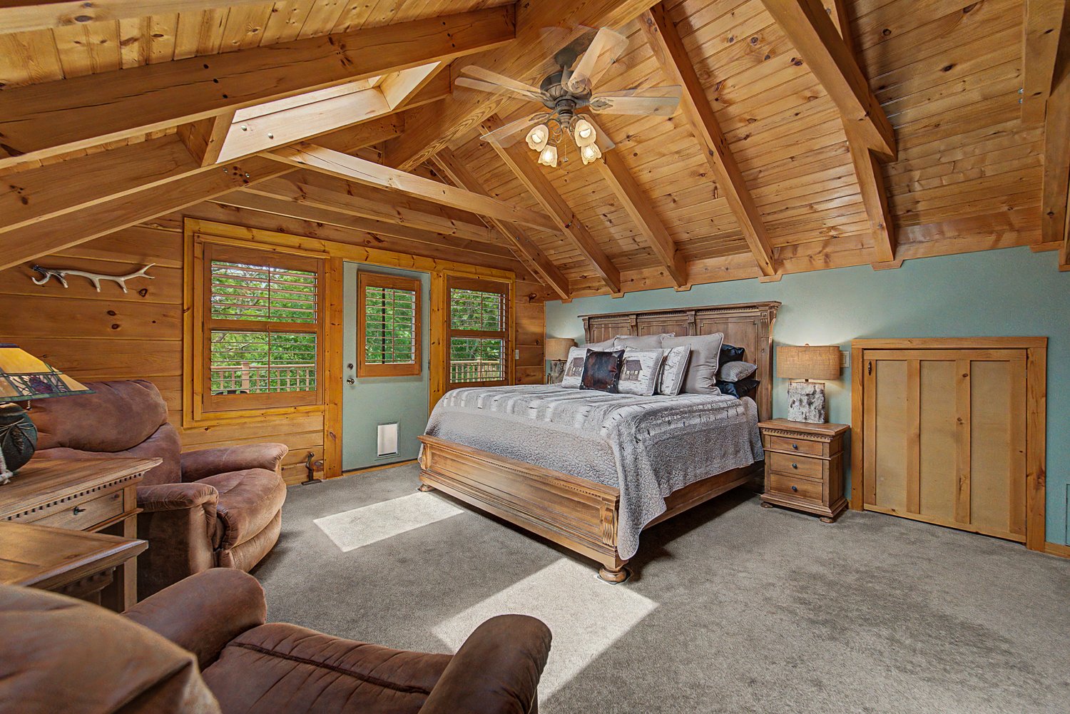 Upper level primary bedroom with a vaulted tongue-and-groove ceiling