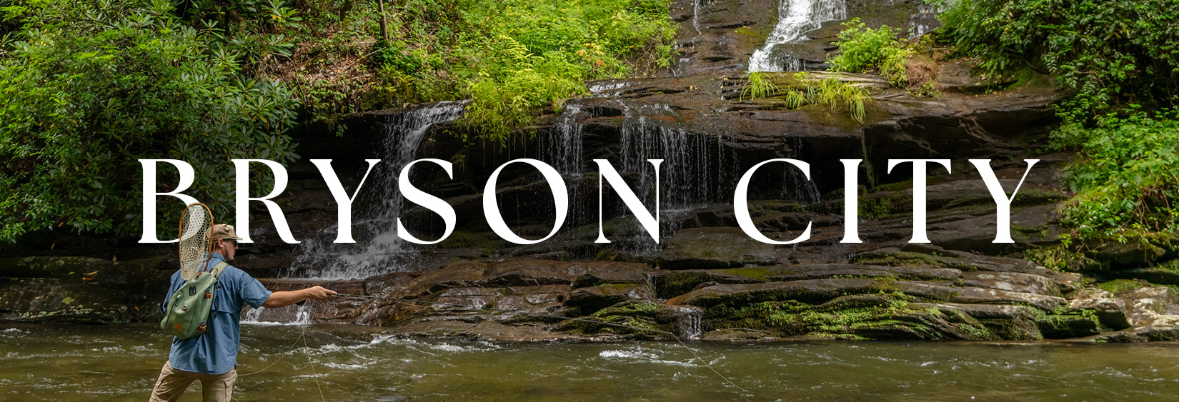 Fly fisherman casting below a waterfall near Bryson City, NC