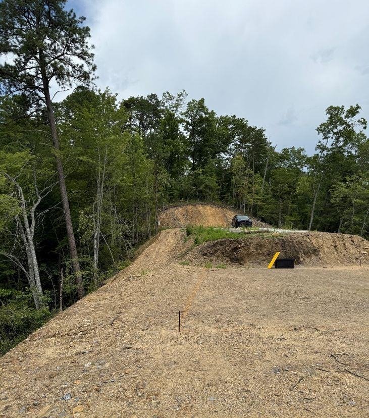 Graded building site with a cut bank and the gravel pad above it