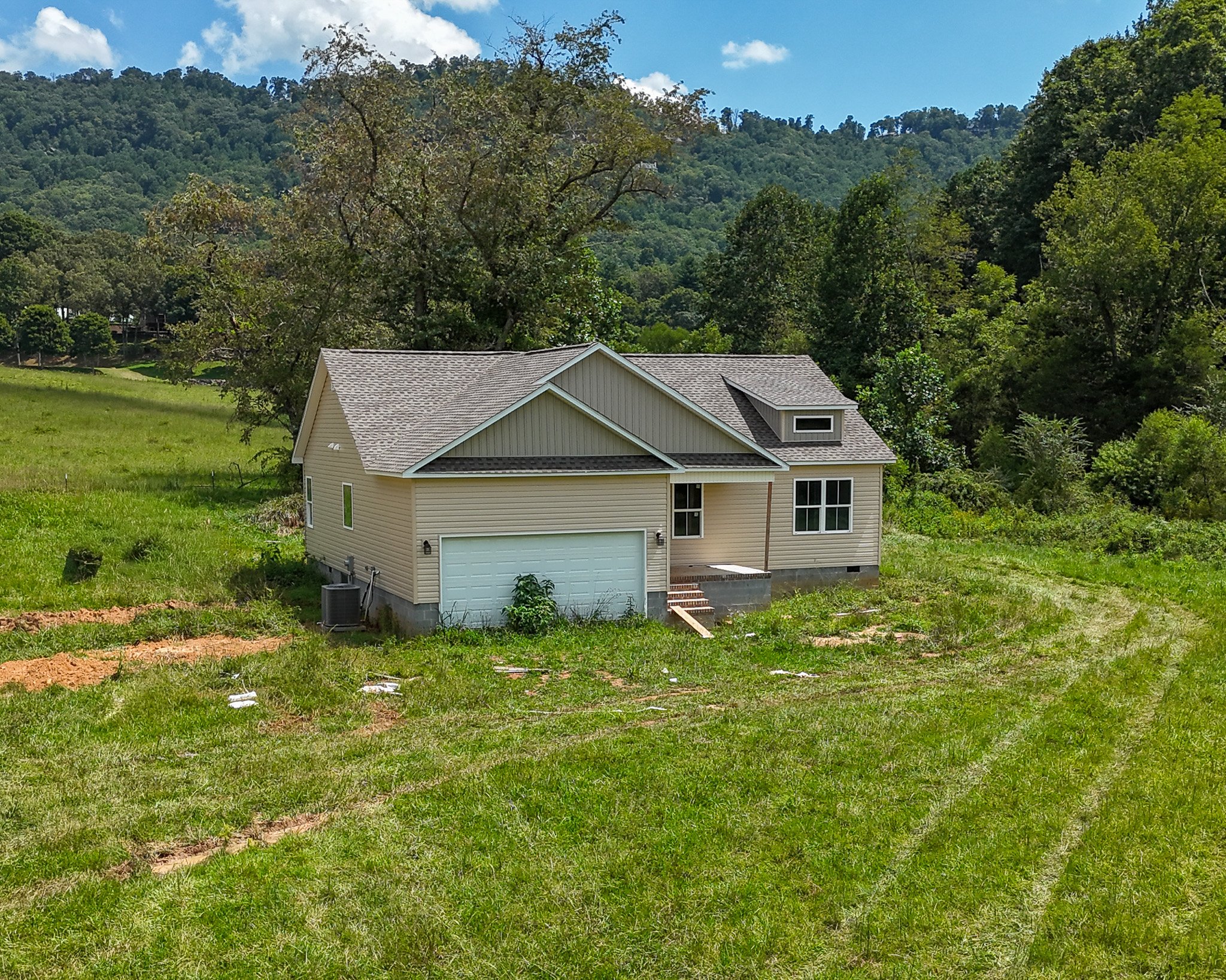 Aerial of the new home at 53 Meadow Ridge Road with its two-car garage and front porch facing the lawn