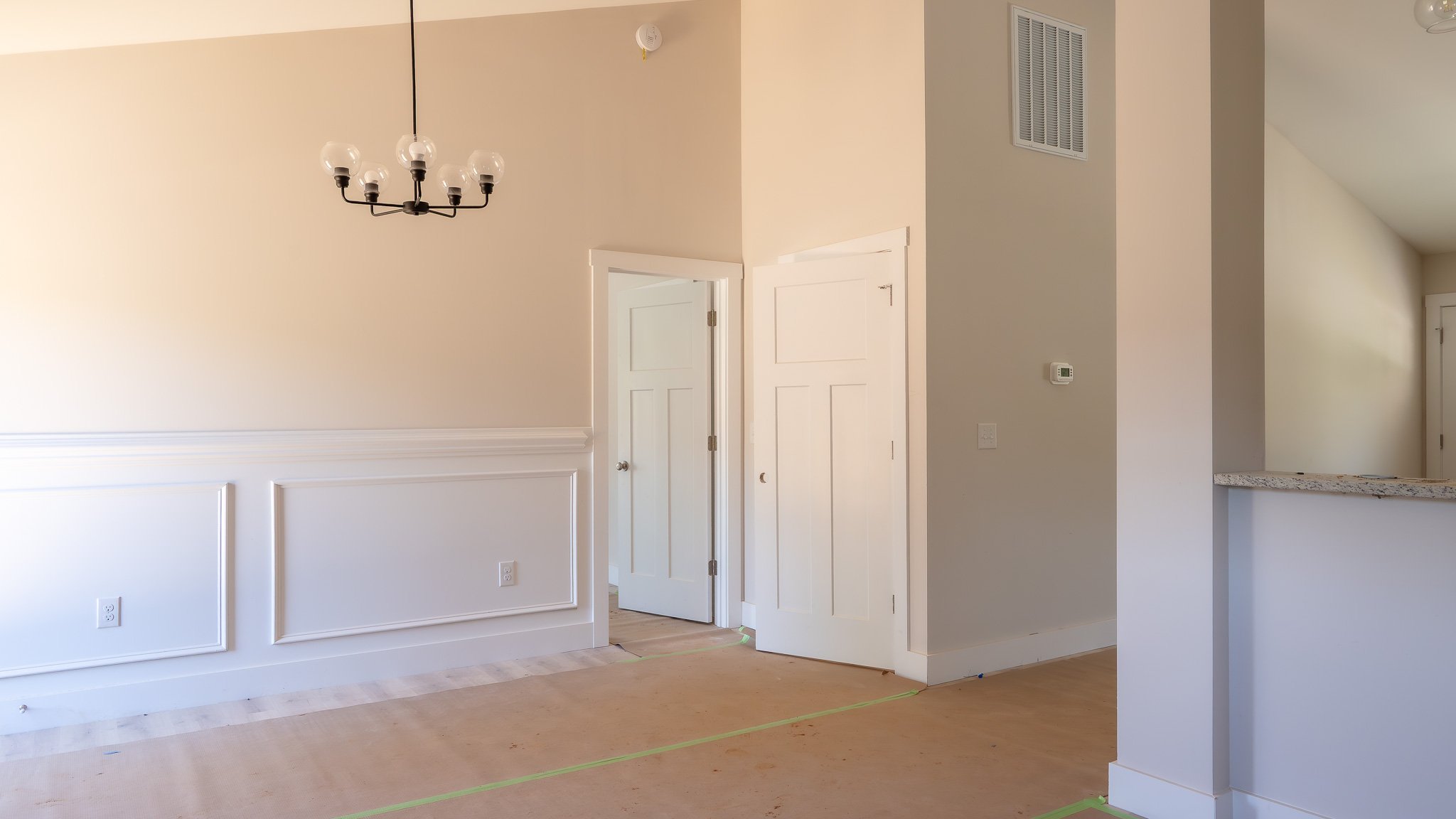 Dining area with wainscoting and a chandelier in the same Charlotte plan built at 40 Meadow Ridge Road