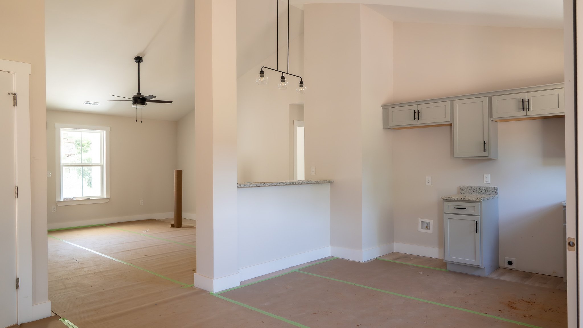 Same Charlotte plan at 40 Meadow Ridge Road: living room open to the kitchen under a vaulted ceiling
