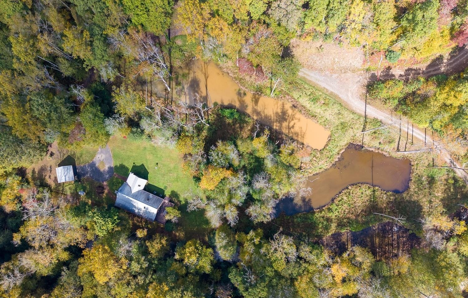 Overhead aerial of 7810 Little Snowbird Road showing the cabin, garage, lawn and two ponds