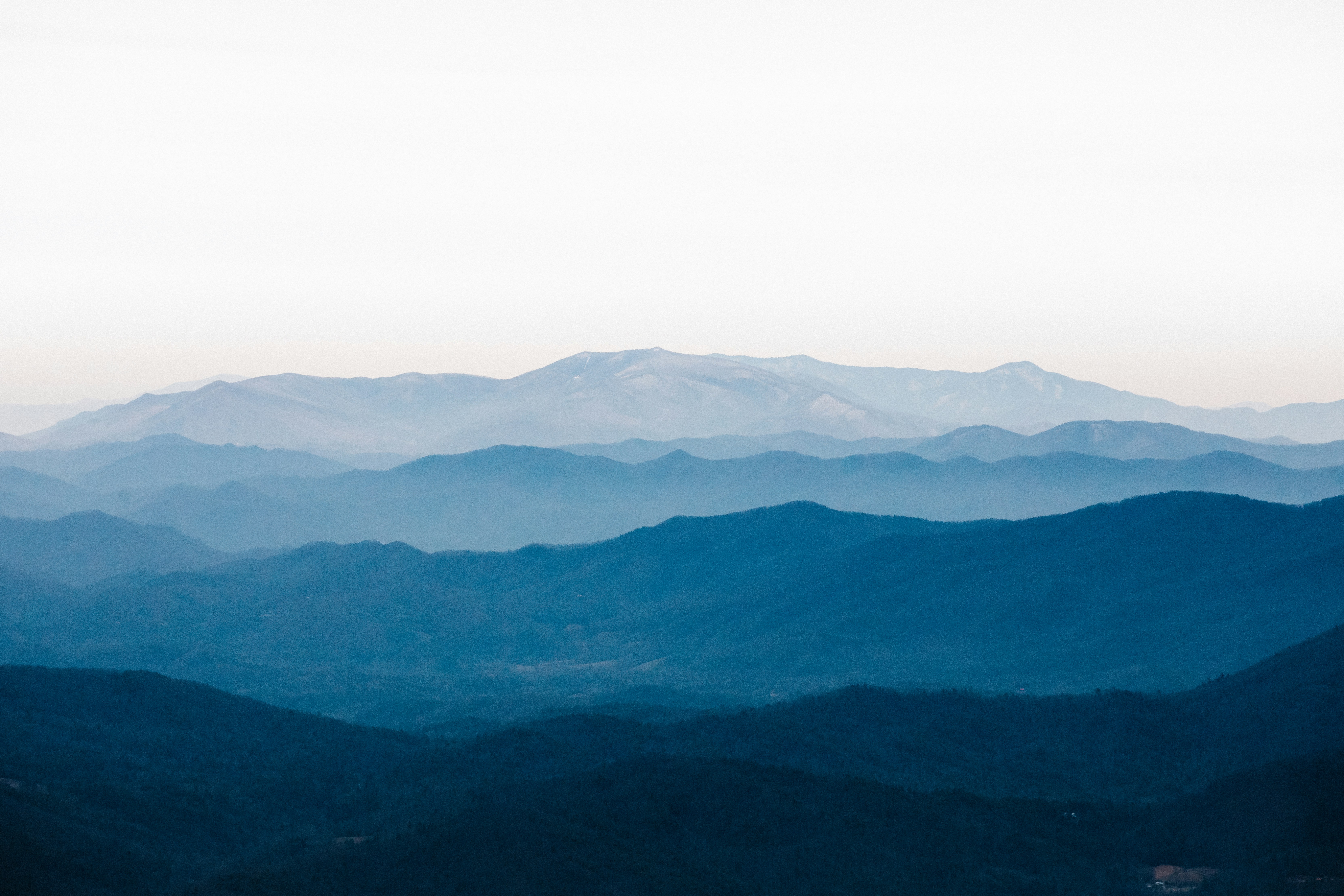 Layered Blue Ridge Mountain ridgelines at sunrise above a quiet valley in Western North Carolina.