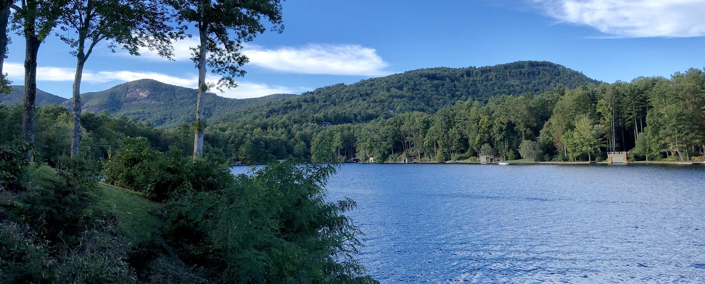 Lake Toxaway seen from the shore at the Greystone Inn, forested ridges across the water