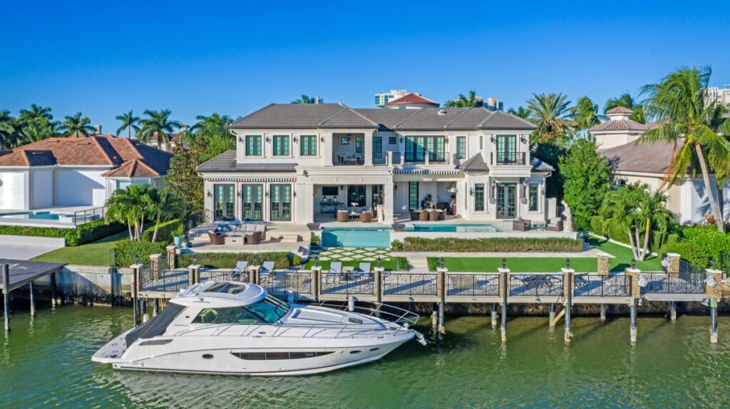 A waterfront luxury estate in Naples with a private dock and yacht