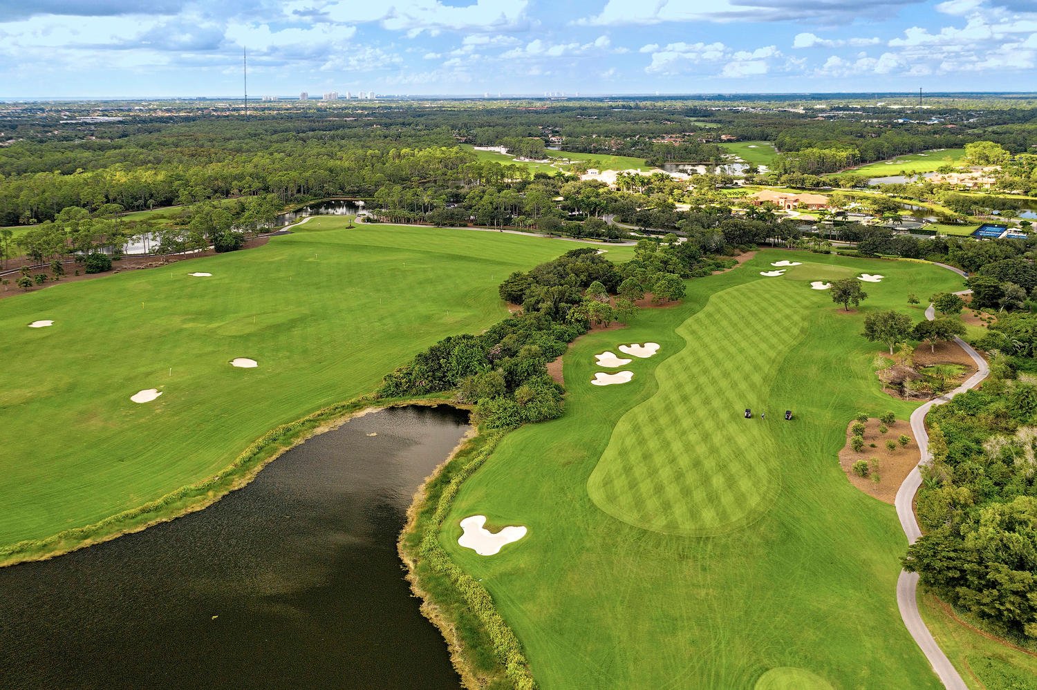 Aerial view of a Naples golf course community with lakes and fairways