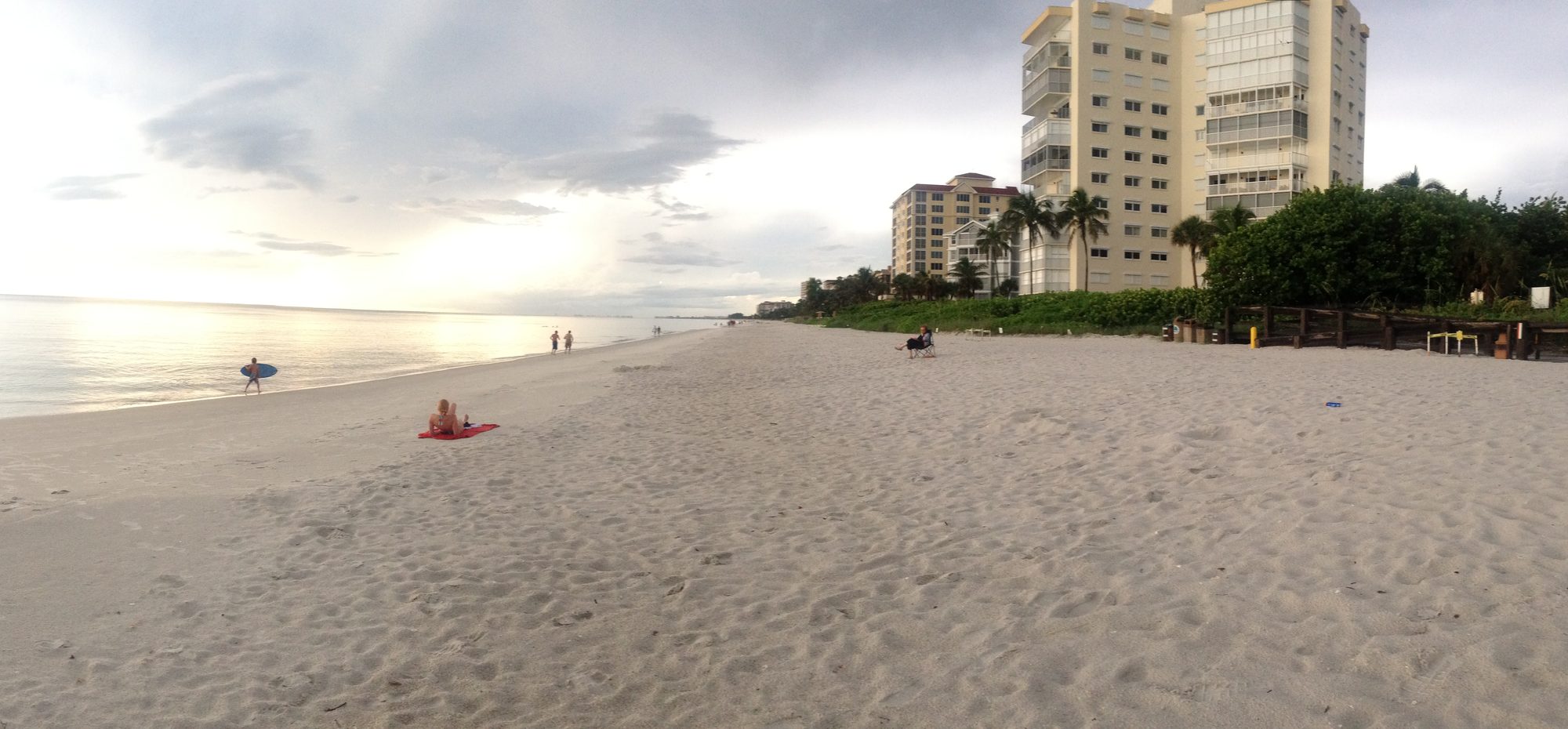 Golden-hour view along the Vanderbilt Beach shoreline and the Gulf Shore Drive condo row in North Naples, Florida