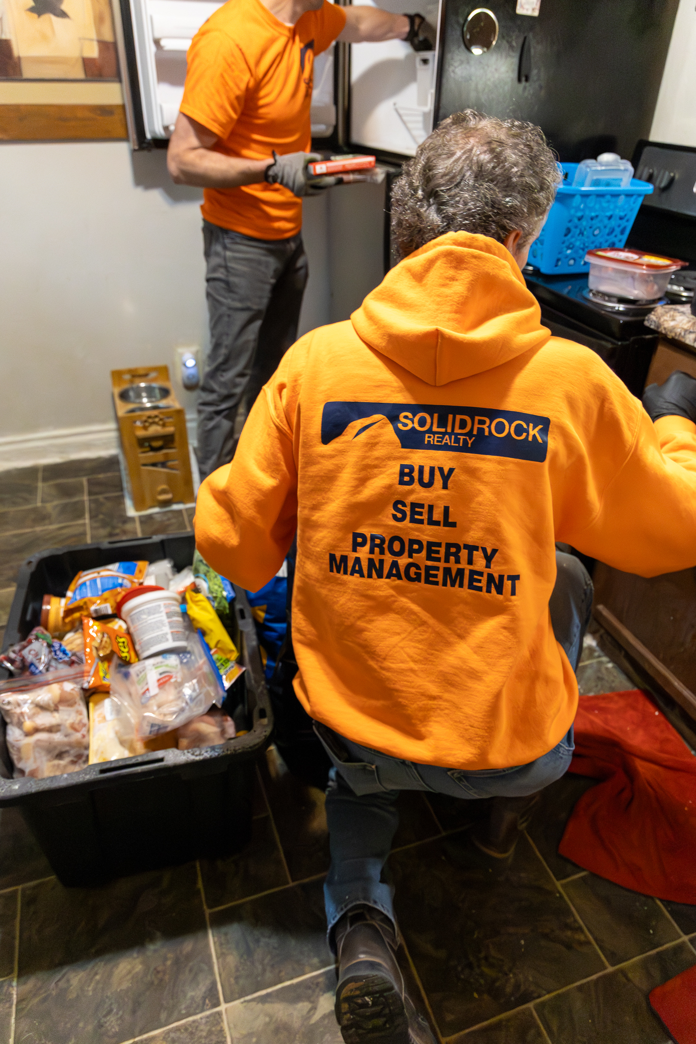 Eviction team clearing refrigerator