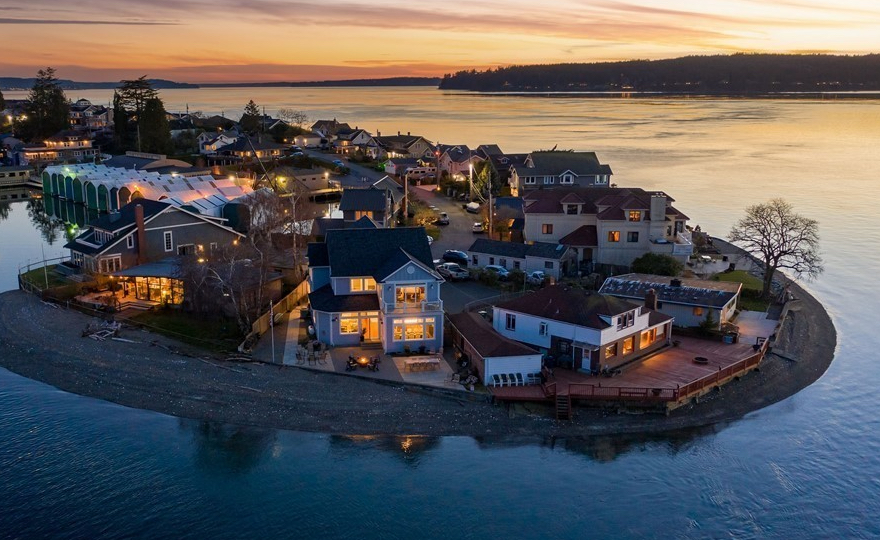 West-facing Day Island waterfront home at sunset with the Olympic Mountains across the Tacoma Narrows