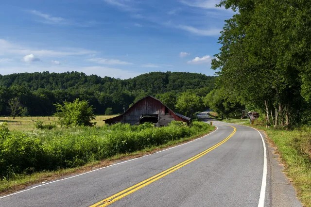 Country road past a barn and pasture in rural Tennessee