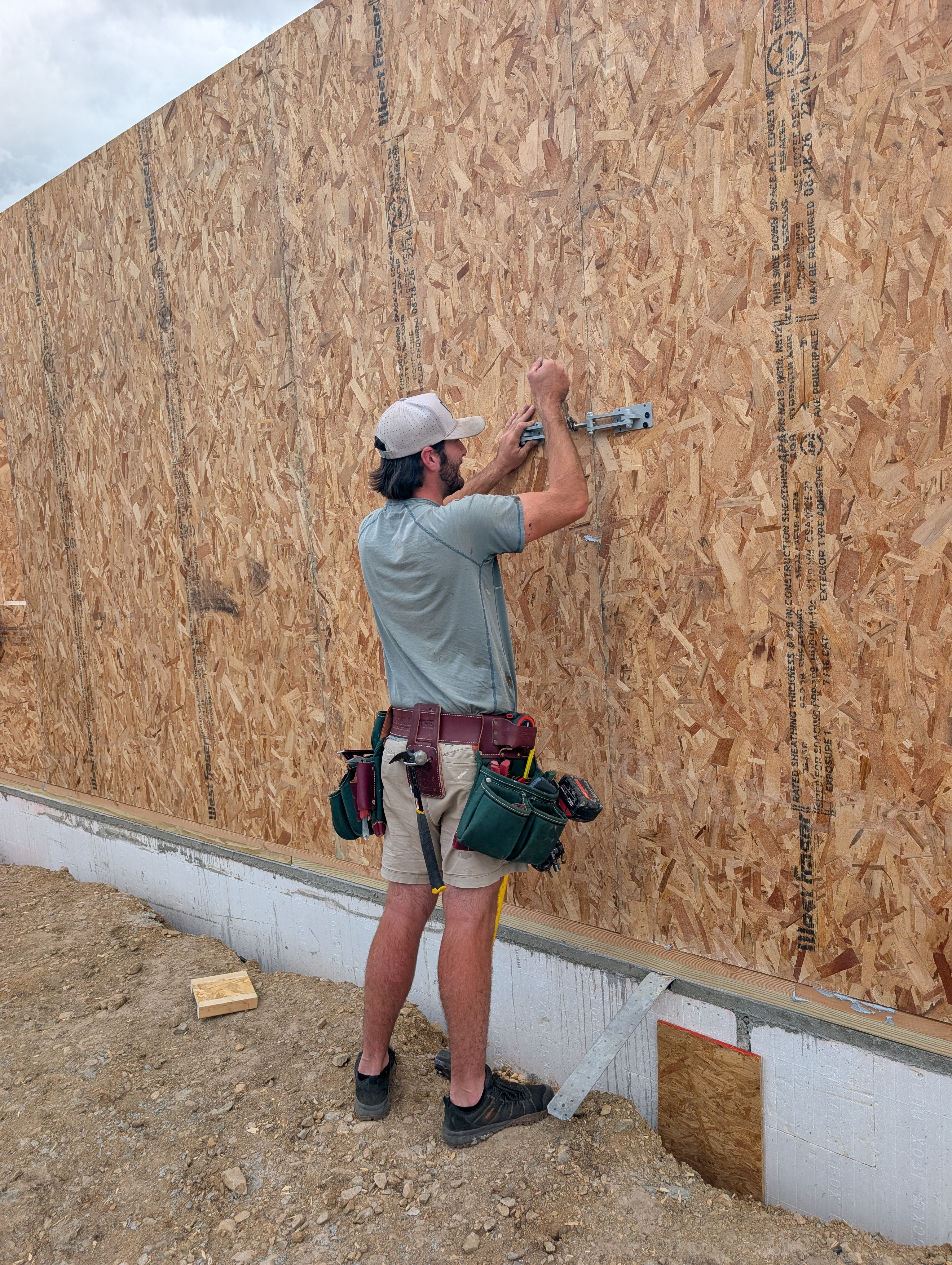 Builder clamping two SIP wall panels together