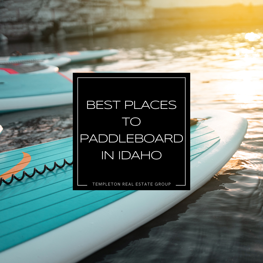 Paddleboards resting on calm water at sunset, highlighting the best places to paddleboard in Idaho. Perfect for outdoor enthusiasts, water sports lovers, and adventure seekers. Image posted byTempleton Real Estate Group.