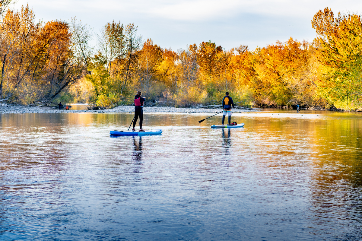 2 people paddle boarding on Boise River