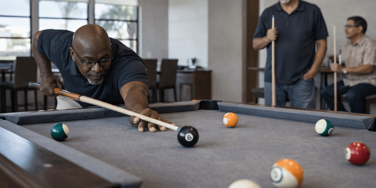 two people playing pool at a community clubhouse in a gilbert 55 + community
