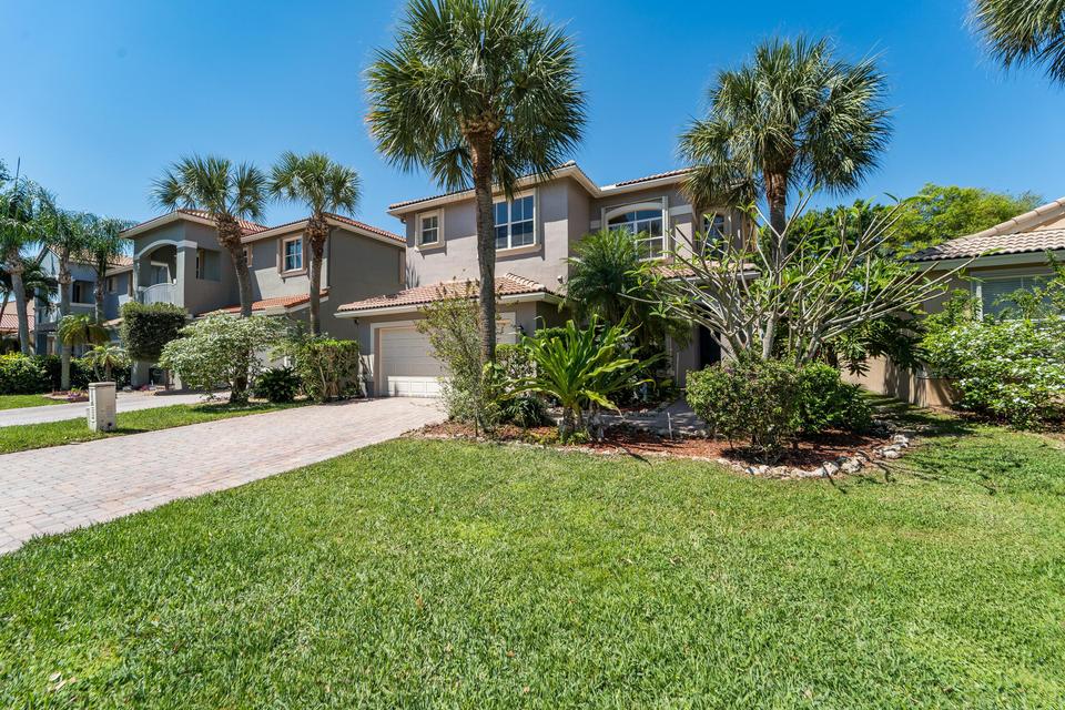 Front exterior of 3 bedroom home for sale in gated Cocoplum community Lake Worth Florida