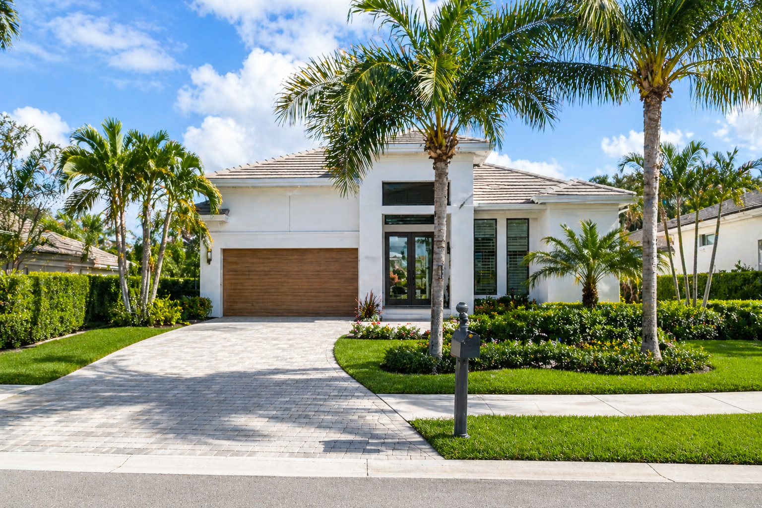 Modern home in Delray Beach FL with palm trees and bright daylight representing local real estate lifestyle and residential setting