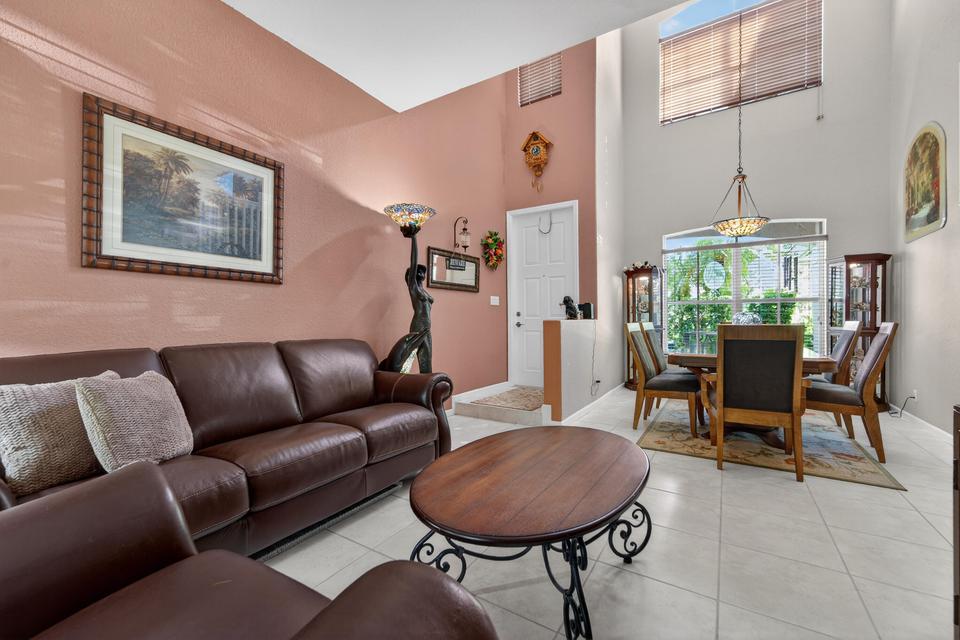 Open family room layout with natural light in Cocoplum home Lake Worth Florida
