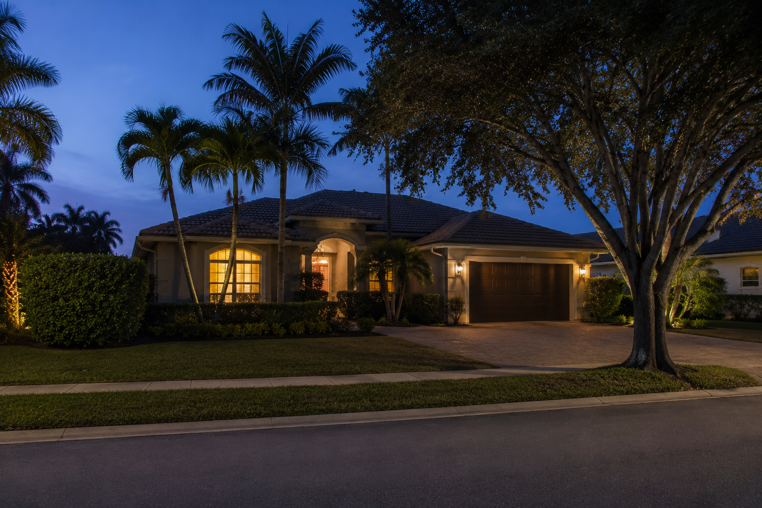 Residential exterior at dusk representing the lived experience behind a carrying figure — a Palm Beach County home occupied rather than marketed. Supports a consumer-education blog asset on identifying financial overreach before committing to a larger home.