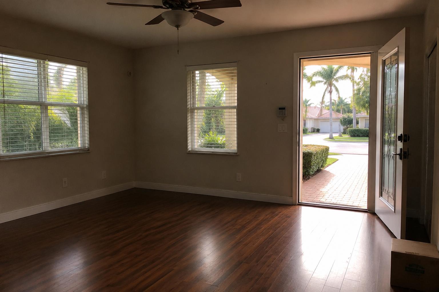 A photorealistic interior scene of a vacant West Palm Beach home mid-probate transition, afternoon light entering through a partially open front door onto empty hardwood floors. The image visually represents the quiet, unresolved period heirs navigate when selling inherited property in Palm Beach County, Florida — a moment between ownership and resolution. Captured in the context of probate real estate and the common decision-making challenges families face during inherited property sales in South Florida.