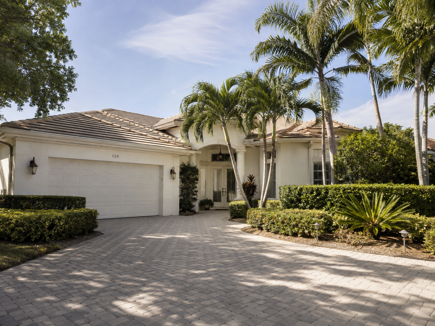 A photorealistic South Florida residential exterior in Palm Beach Gardens captures the emotional register of a homeowner transition &mdash; the stillness of a well-kept property whose upkeep demands have outpaced its enjoyment. The scene pairs naturally with the asset's central theme of lower-maintenance home decisions and lifestyle simplification for Palm Beach County homeowners considering the Port St. Lucie market. Soft afternoon light and clean architectural lines reinforce the visual language of intentional simplification rather than neglect or urgency.