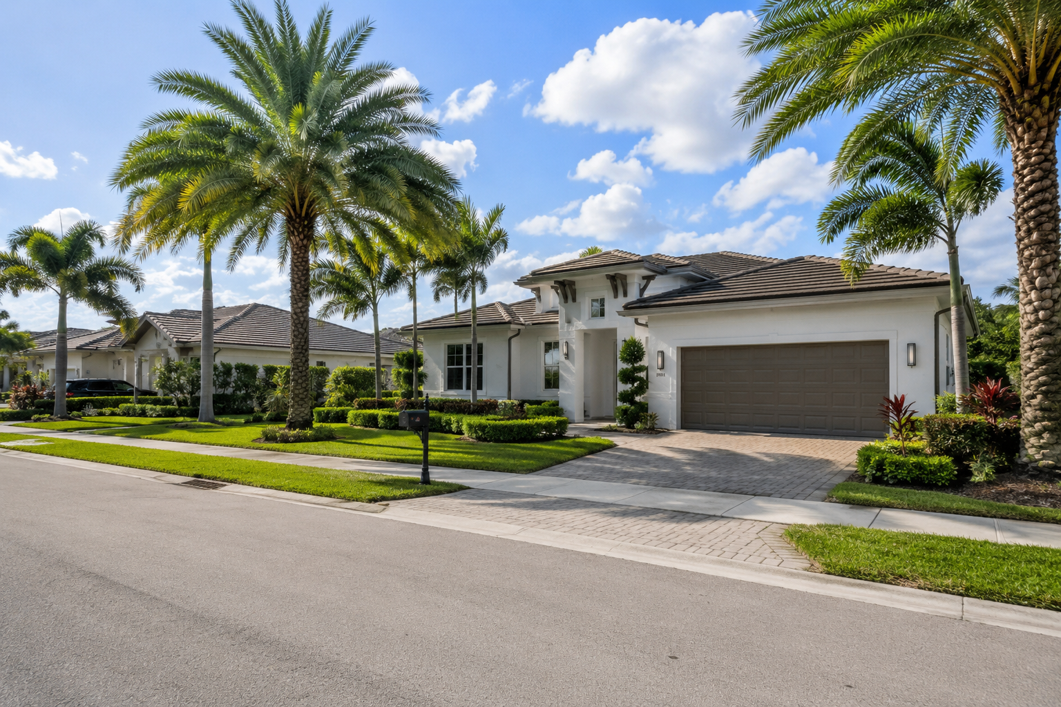 Bright open living room in a newer Port St. Lucie home with sliding glass doors to a simple backyard, representing lower-maintenance lifestyle living.