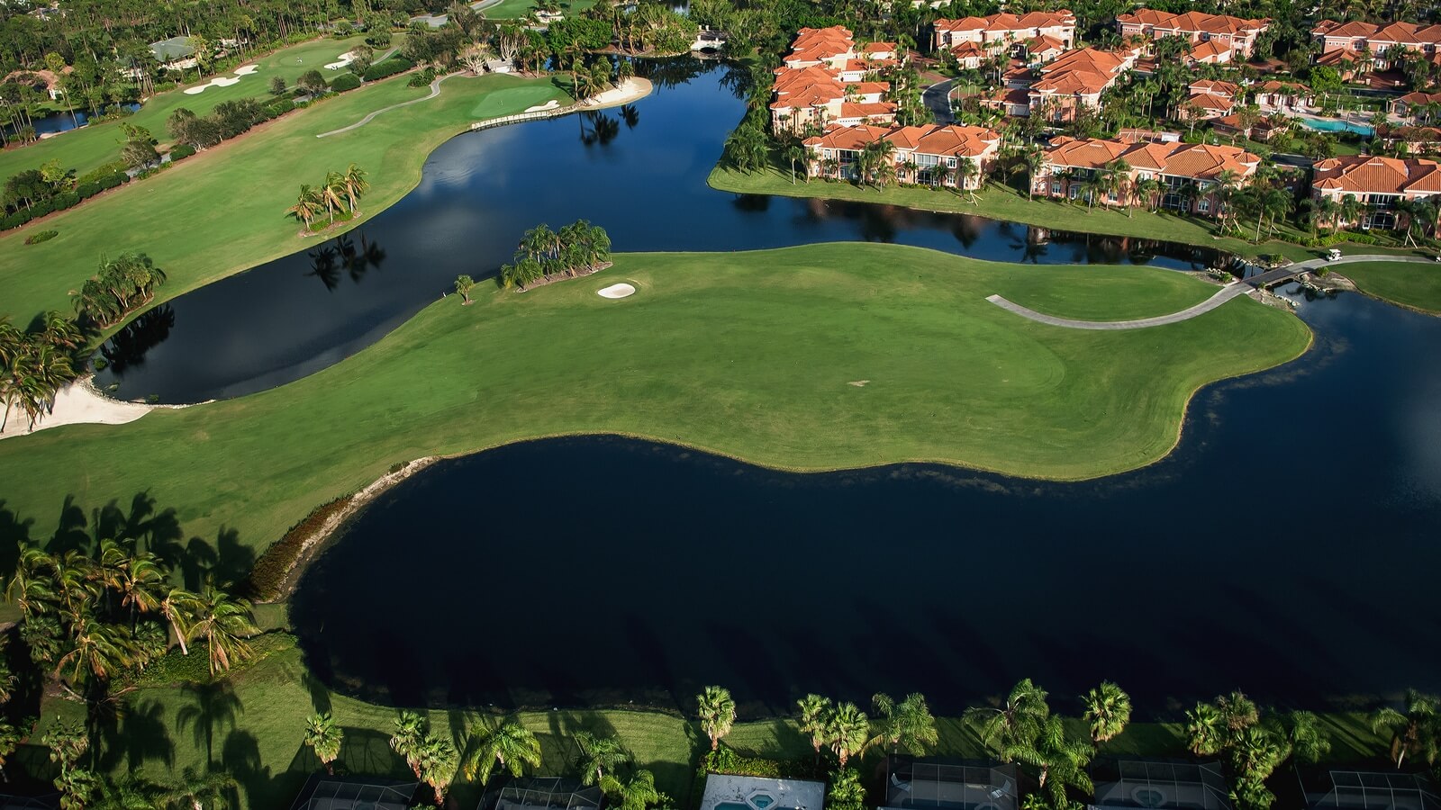 Luxury home with a pool overlooking a golf course