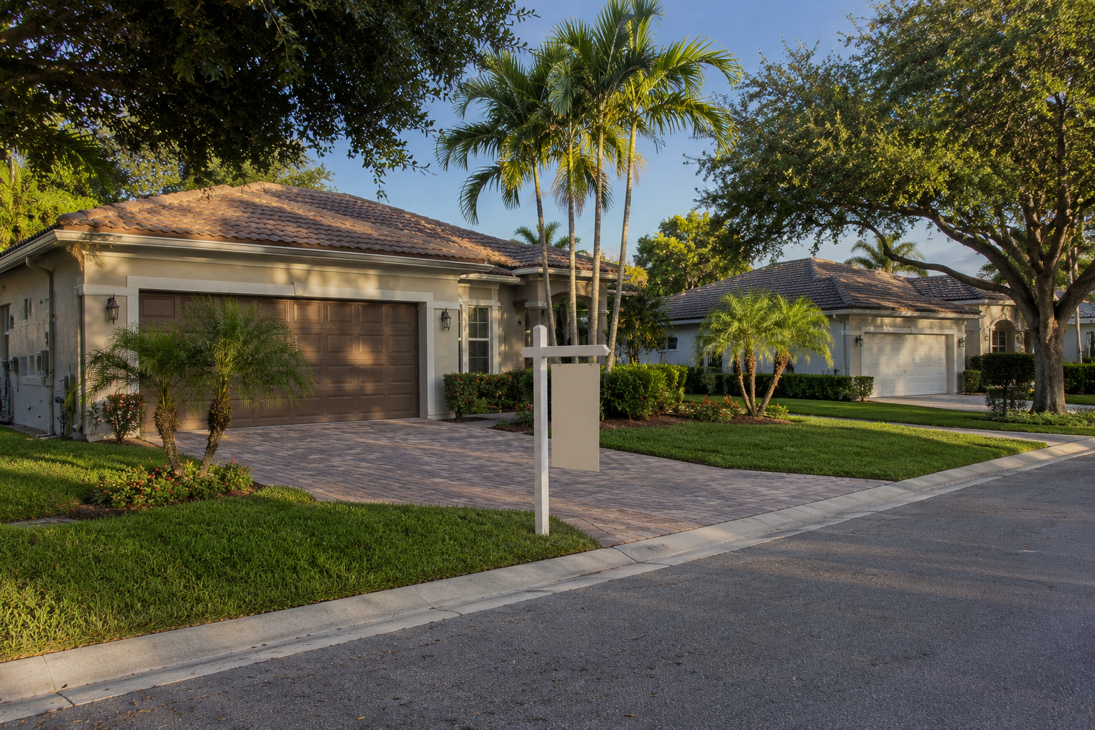 Residential street scene representing the coordination between selling one Palm Beach County home and buying another. Supports a consumer-education blog asset comparing sell-first, buy-first, contingent-offer and bridge-financing sequencing approaches.