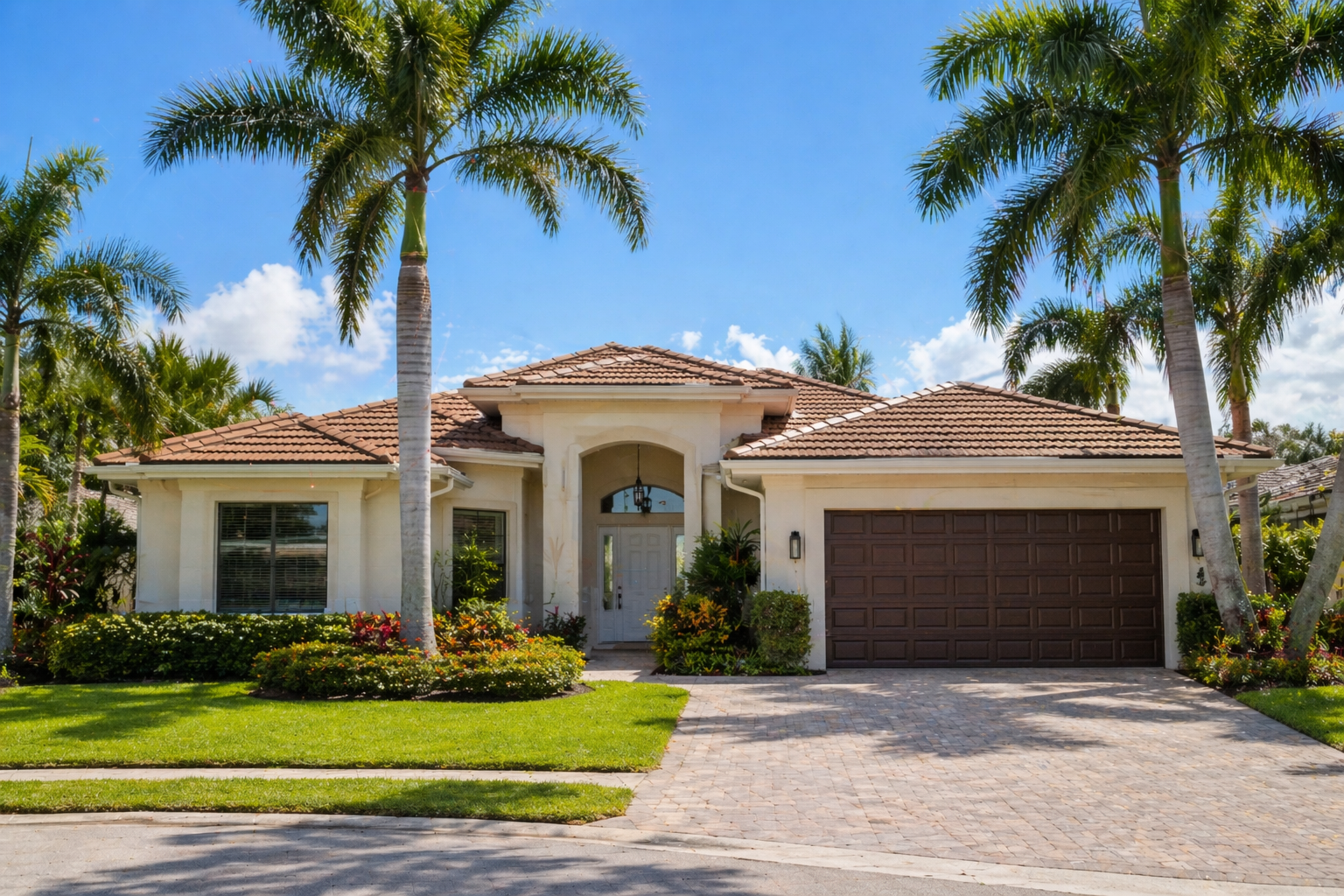A bright South Florida home in West Palm Beach FL real estate market with palm trees and clean exterior under sunny blue sky