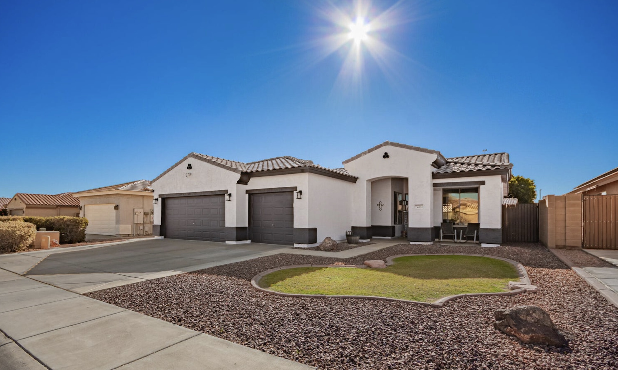 Single-story Ashton Ranch home with a three-car garage in Surprise, Arizona