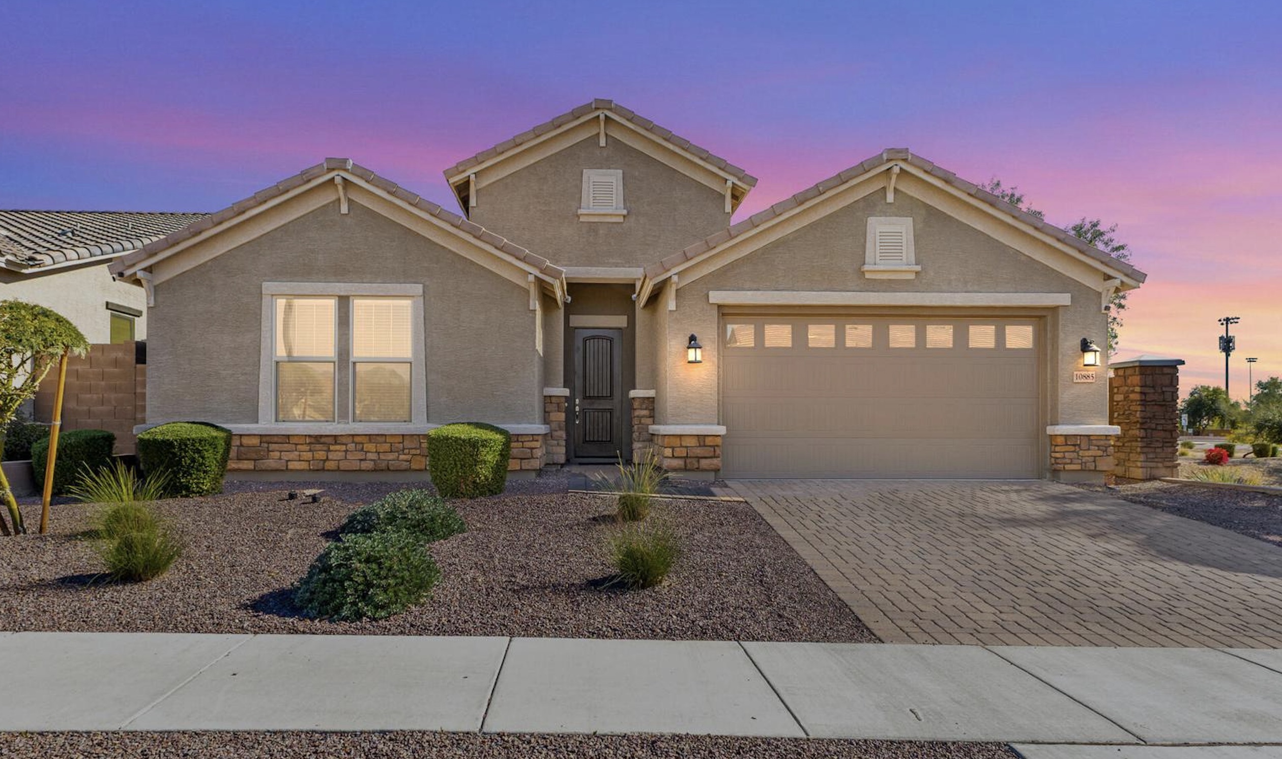 Single-story home at sunset in Zanjero Trails in Surprise Arizona