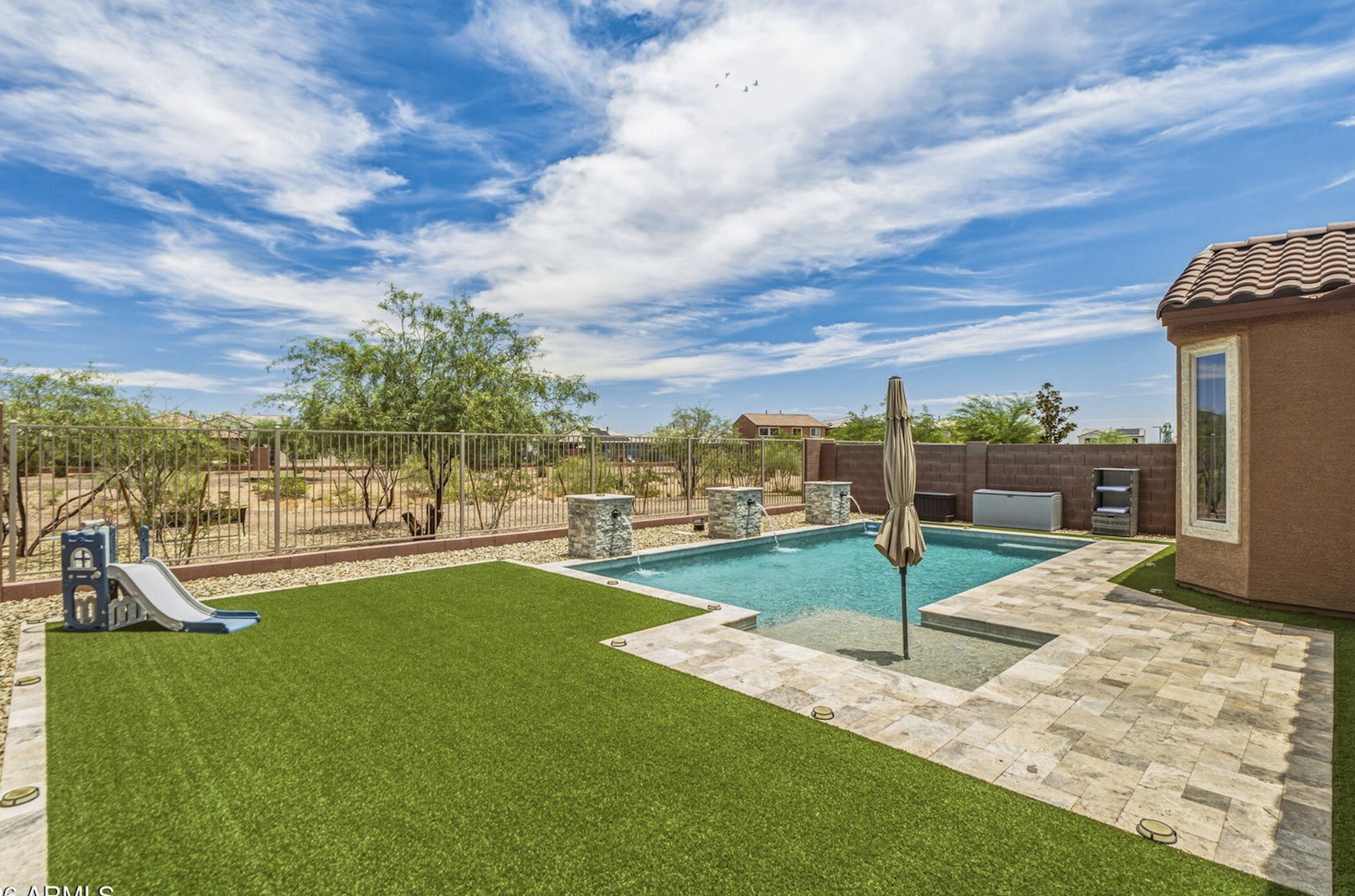 Private pool and landscaped backyard at a Desert Oasis home in Surprise Arizona